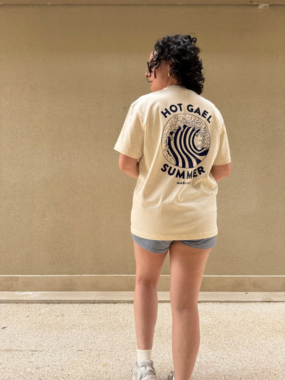 Person wearing a cream t-shirt with Hot Gael Summer text and graphics, standing on a plain background